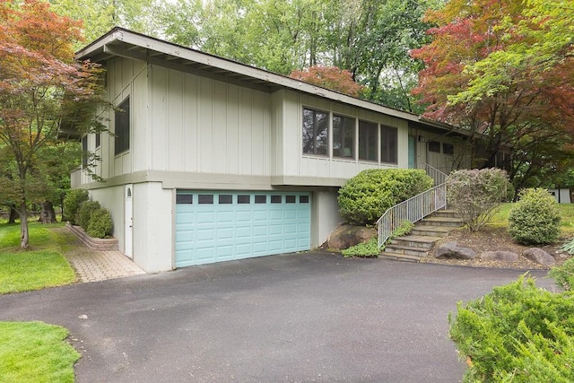14 Wesley Ct, Congers, NY 10920 - view of front facade featuring asphalt driveway and a garage