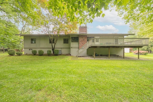 14 Wesley Ct, Congers, NY 10920 - rear view of property featuring a deck, a chimney, a lawn, stairway, and central AC