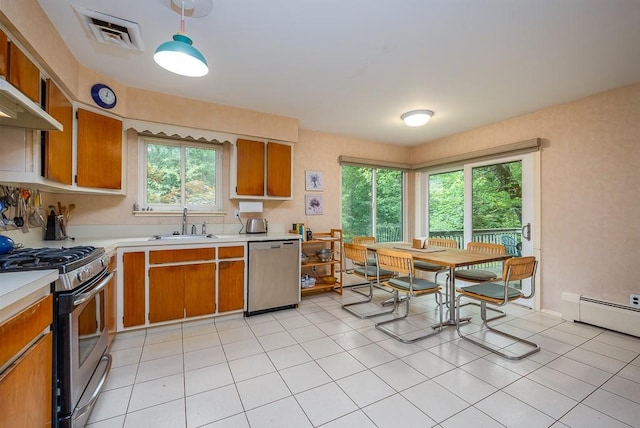 14 Wesley Ct, Congers, NY 10920 - kitchen featuring appliances with stainless steel finishes, light countertops, a sink, brown cabinetry, and light tile patterned floors
