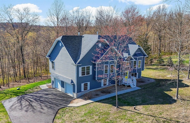 12 Hill Rd, Washingtonville, NY 10992 - view of front of property featuring a wooded view, aphalt driveway, a shingled roof, an attached garage, and a front lawn