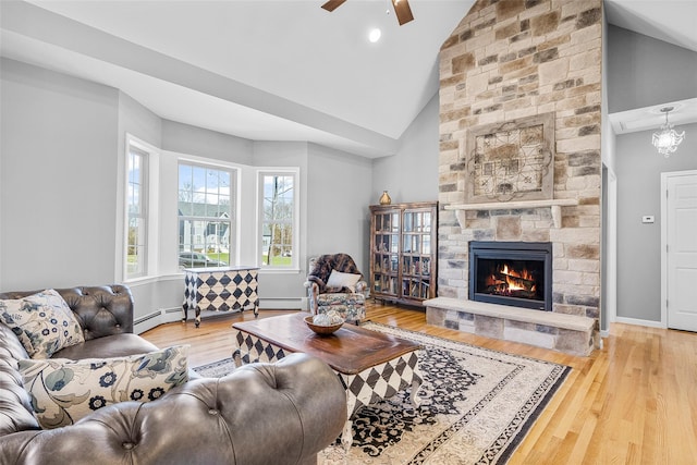 12 Hill Rd, Washingtonville, NY 10992 - living area with a baseboard radiator, wood finished floors, a ceiling fan, high vaulted ceiling, and a stone fireplace
