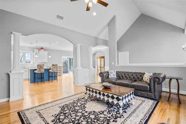 12 Hill Rd, Washingtonville, NY 10992 - living room featuring visible vents, arched walkways, ornate columns, and light wood-style flooring