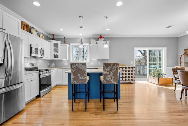 12 Hill Rd, Washingtonville, NY 10992 - kitchen featuring crown molding, a breakfast bar area, appliances with stainless steel finishes, and a wealth of natural light