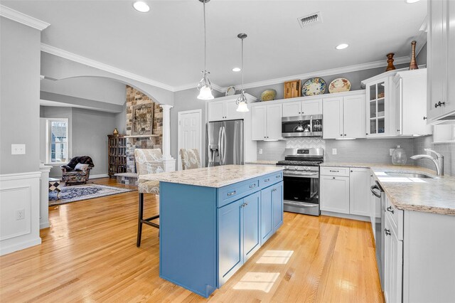 12 Hill Rd, Washingtonville, NY 10992 - kitchen featuring a sink, appliances with stainless steel finishes, visible vents, blue cabinetry, and ornate columns