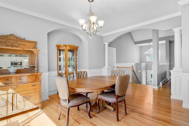 12 Hill Rd, Washingtonville, NY 10992 - dining space with arched walkways, an inviting chandelier, wainscoting, a baseboard heating unit, and light wood-style floors