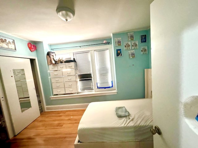 bedroom with wood finished floors