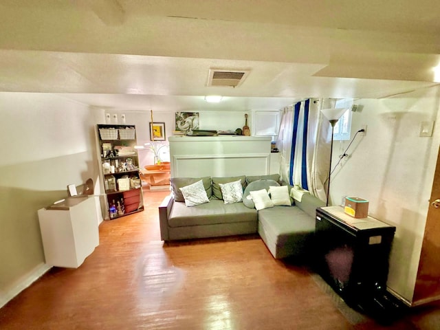 living room featuring visible vents and wood finished floors