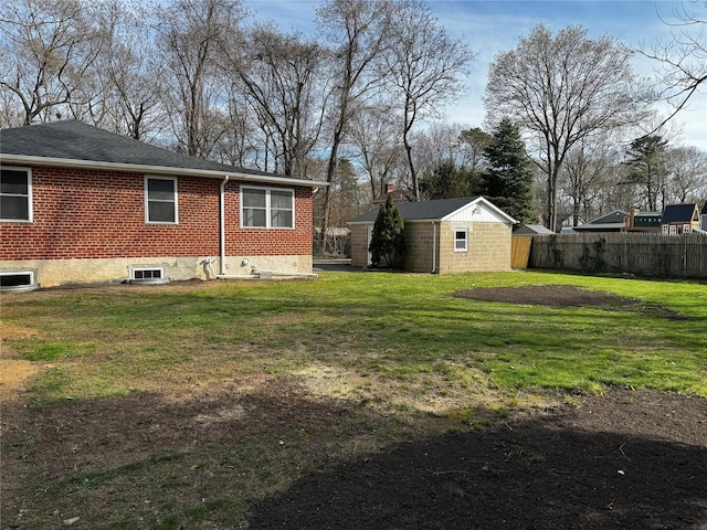 view of yard with an outdoor structure, a shed, and fence