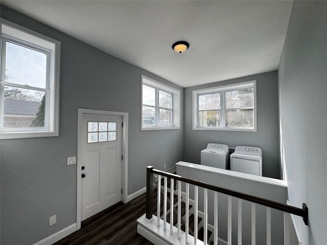entryway featuring washing machine and clothes dryer, baseboards, and dark wood-style floors