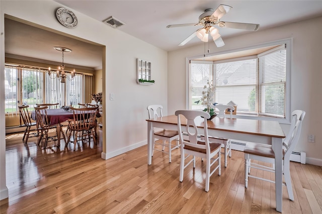 5 Cottonwood Ave, Port Jefferson Station, NY 11776 - dining space featuring light wood-type flooring, baseboards, visible vents, ceiling fan with notable chandelier, and baseboard heating