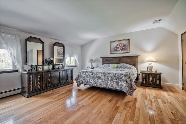 5 Cottonwood Ave, Port Jefferson Station, NY 11776 - bedroom featuring vaulted ceiling, baseboards, visible vents, wood finished floors, and a baseboard radiator