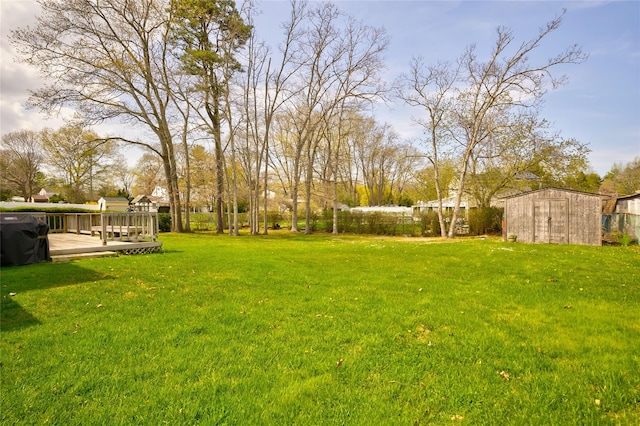 5 Cottonwood Ave, Port Jefferson Station, NY 11776 - view of yard with fence, a deck, an outdoor structure, and a shed