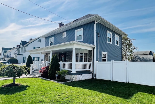 exterior space featuring a yard, covered porch, and fence