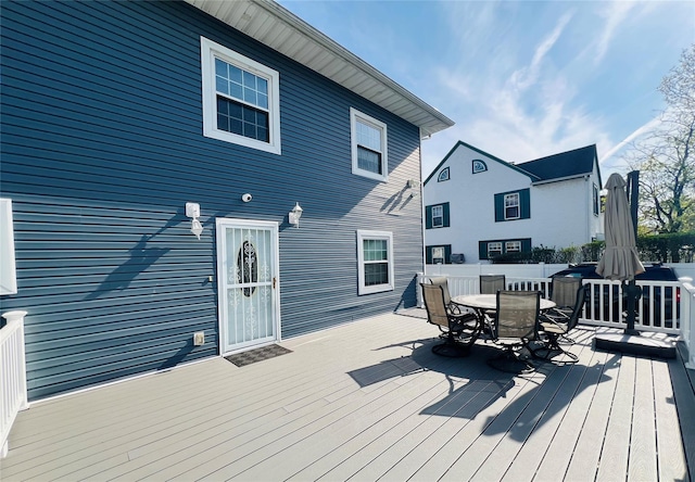 wooden deck featuring outdoor dining area