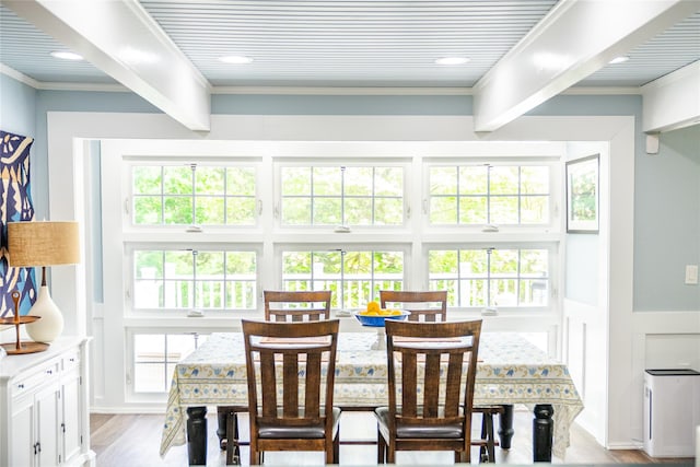 2 Spring Hollow Rd, Centerport, NY 11721 - dining space featuring wood finished floors, a wainscoted wall, and crown molding