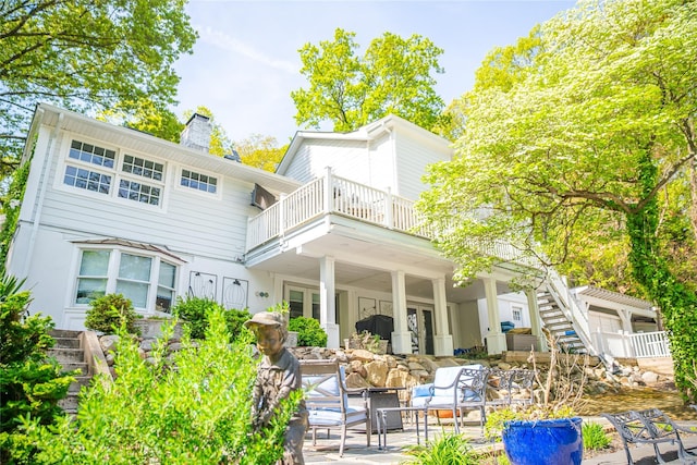 2 Spring Hollow Rd, Centerport, NY 11721 - back of property with a patio area, a chimney, and a balcony