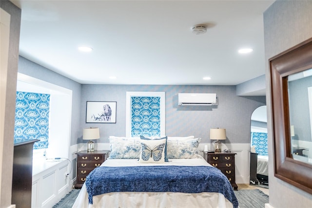 2 Spring Hollow Rd, Centerport, NY 11721 - bedroom with a wall mounted air conditioner, wood finished floors, arched walkways, recessed lighting, and wallpapered walls