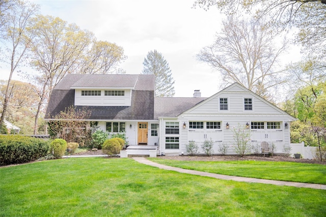 2 Spring Hollow Rd, Centerport, NY 11721 - view of front facade with a chimney, a front yard, a garage, and roof with shingles