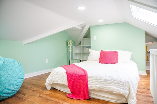 2 Spring Hollow Rd, Centerport, NY 11721 - bedroom with vaulted ceiling, wood finished floors, a skylight, and recessed lighting