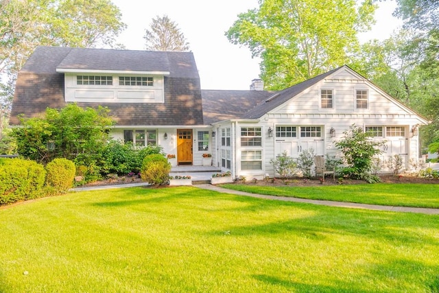 2 Spring Hollow Rd, Centerport, NY 11721 - view of front of home with a front yard and a chimney
