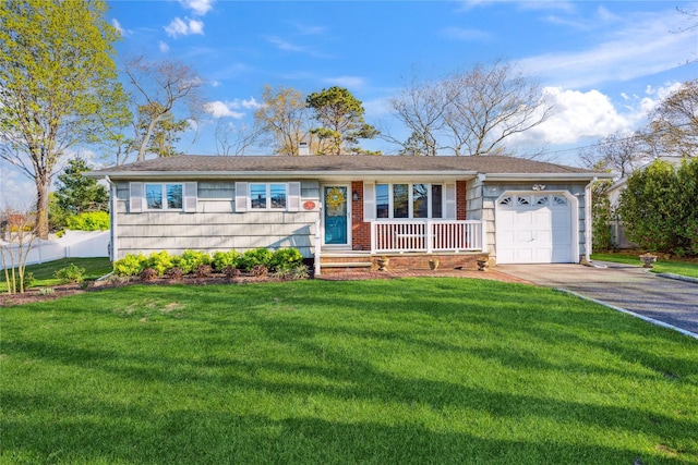 169 Loop Dr, Sayville, NY 11782 - ranch-style house featuring a porch, a chimney, a front yard, a garage, and aphalt driveway