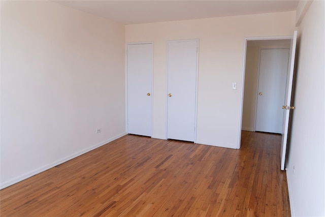 unfurnished bedroom featuring baseboards and light wood-style flooring