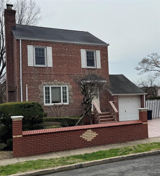 111-54 178th Pl, Addisleigh Park, NY 11433 - view of front of house with brick siding, a chimney, a garage, and roof with shingles