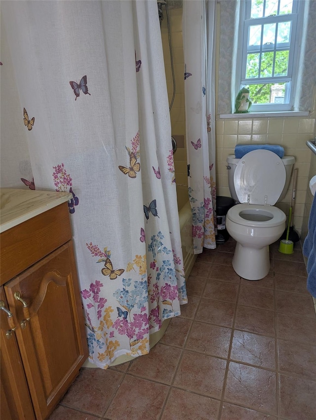 bathroom featuring vanity, shower / bathtub combination with curtain, tile patterned flooring, and toilet