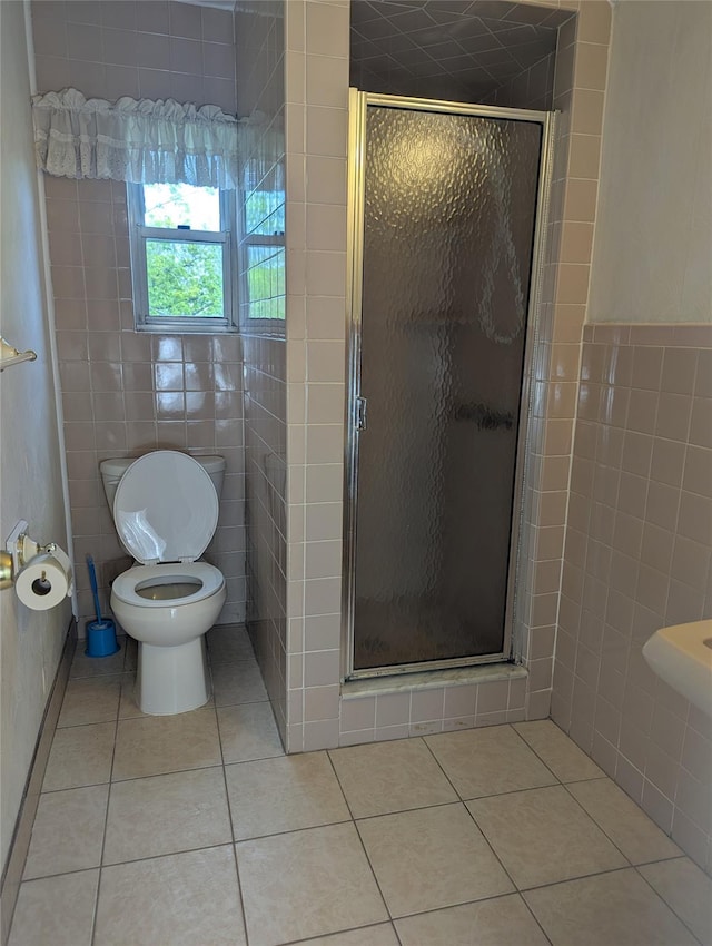full bathroom featuring tile patterned floors, tile walls, and a stall shower