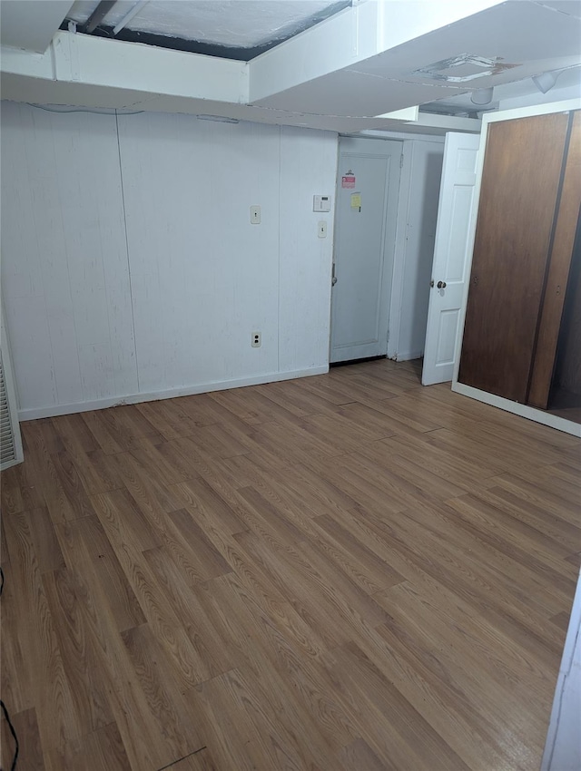 finished basement with baseboards and wood finished floors