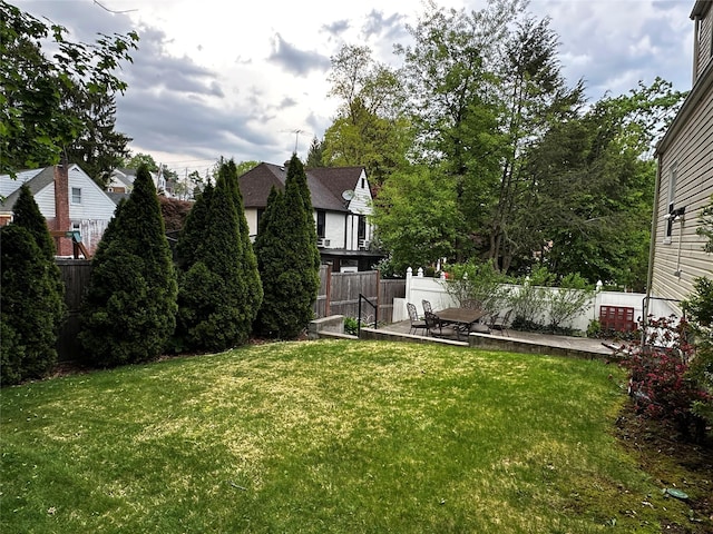 view of yard featuring fence and a patio area