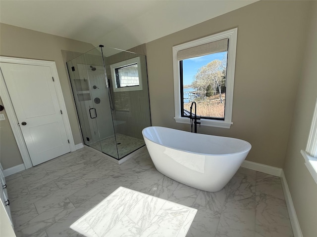 bathroom with baseboards, a soaking tub, a shower stall, and marble finish floor