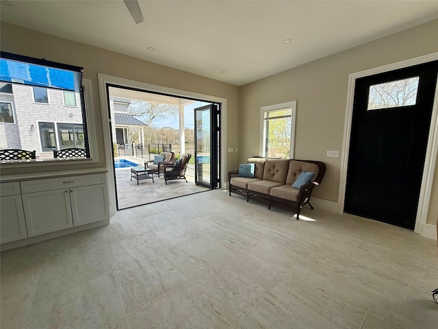 living area featuring baseboards