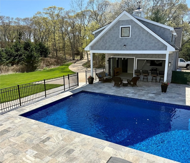 view of pool with fence, a patio area, a storage structure, and a fenced in pool