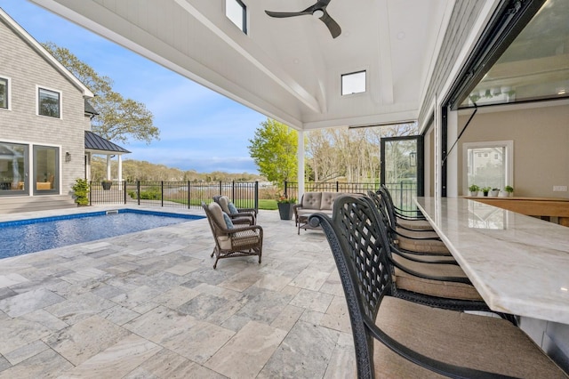 view of patio featuring an outdoor hangout area, fence, a fenced in pool, and ceiling fan