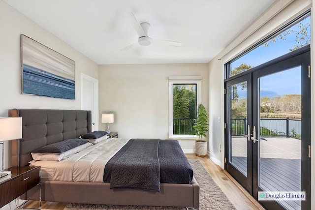 bedroom with ceiling fan, access to exterior, french doors, and light wood finished floors