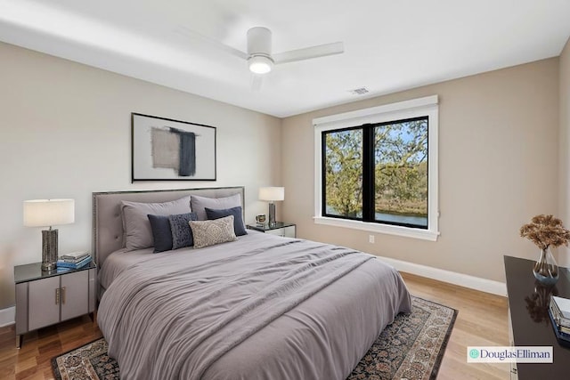 bedroom featuring baseboards, ceiling fan, and wood finished floors