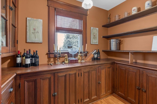 bar featuring bar area and light wood finished floors