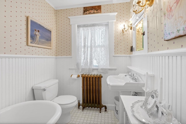 bathroom featuring radiator, crown molding, a wainscoted wall, and toilet