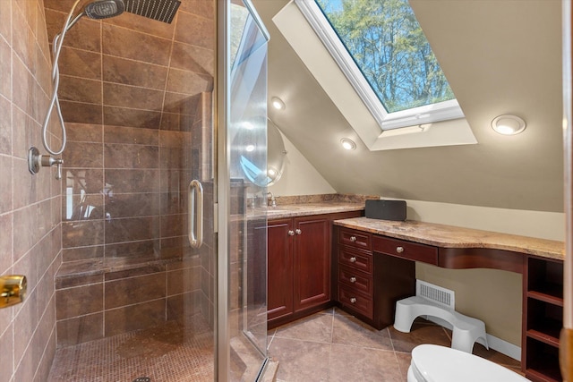 full bath with lofted ceiling with skylight, toilet, a stall shower, tile patterned flooring, and vanity