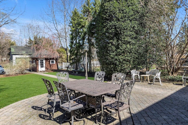 view of patio with an outdoor structure and outdoor dining space