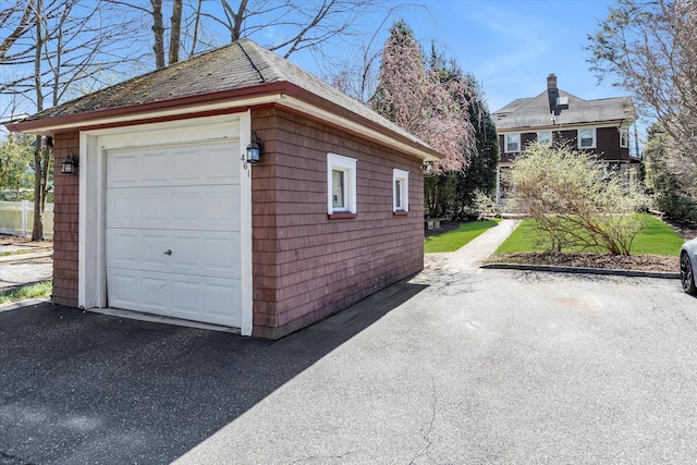 garage with aphalt driveway