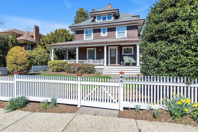view of front facade with a fenced front yard and covered porch