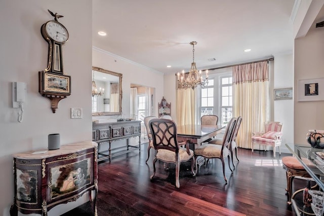 dining space featuring dark wood finished floors, an inviting chandelier, and crown molding