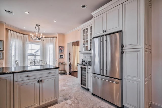kitchen with wine cooler, visible vents, high end refrigerator, crown molding, and a notable chandelier