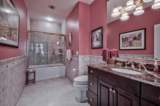 bathroom with tile walls, tile patterned floors, visible vents, and toilet