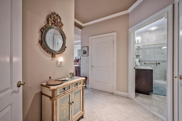 corridor featuring light carpet, baseboards, and ornamental molding