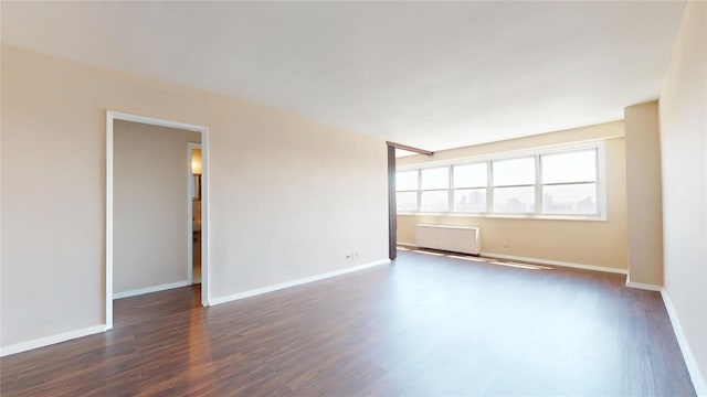 66-36 Yellowstone Blvd Unit 21C, Forest Hills, NY 11375 - unfurnished room featuring baseboards, dark wood-style floors, and radiator