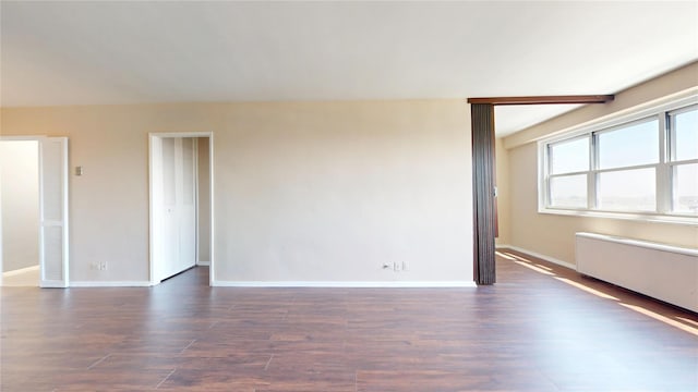 66-36 Yellowstone Blvd Unit 21C, Forest Hills, NY 11375 - spare room featuring baseboards and dark wood-style floors