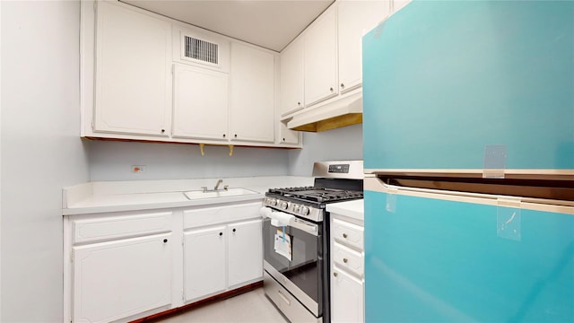 66-36 Yellowstone Blvd Unit 21C, Forest Hills, NY 11375 - kitchen featuring visible vents, stainless steel range with gas stovetop, a sink, freestanding refrigerator, and under cabinet range hood